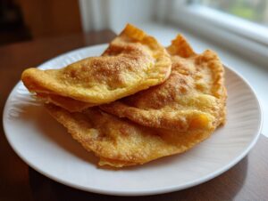 Close-up of golden, puffy fried tortillas ready to be filled for potato tacos.